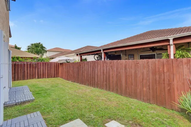 a backyard of a house with wooden fence