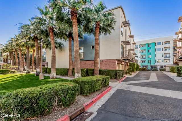 a front view of multiple houses with yard