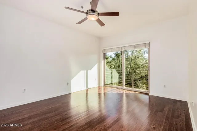 a view of room with wooden floor and fan