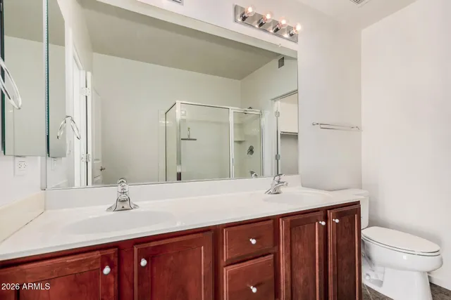 a bathroom with a sink vanity granite and toilet
