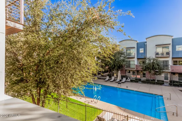 a view of a building with sitting area and garden