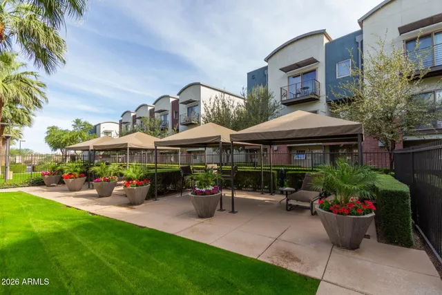 a view of swimming pool with outdoor seating and a garden