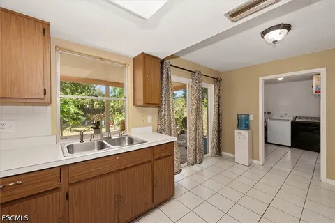 a kitchen with a sink and a large window