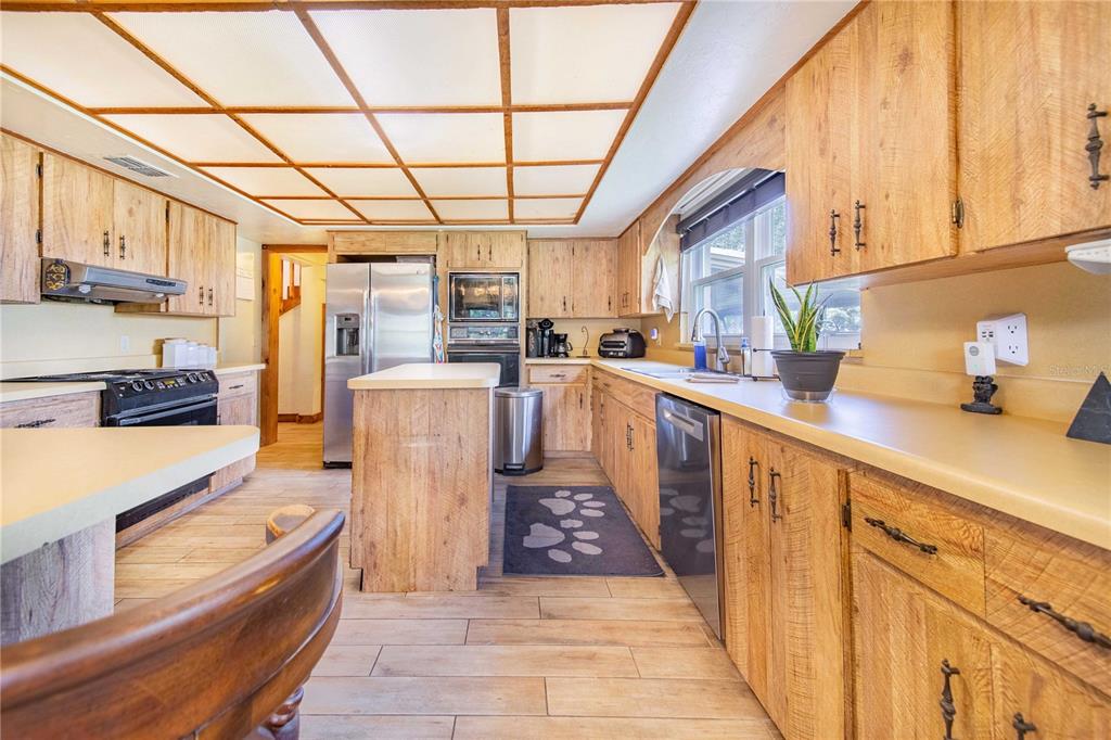 1646 Tyner Road Haines City, FL 33844 - Photo 17 of 64 a kitchen with stainless steel appliances granite countertop a sink stove and cabinets
