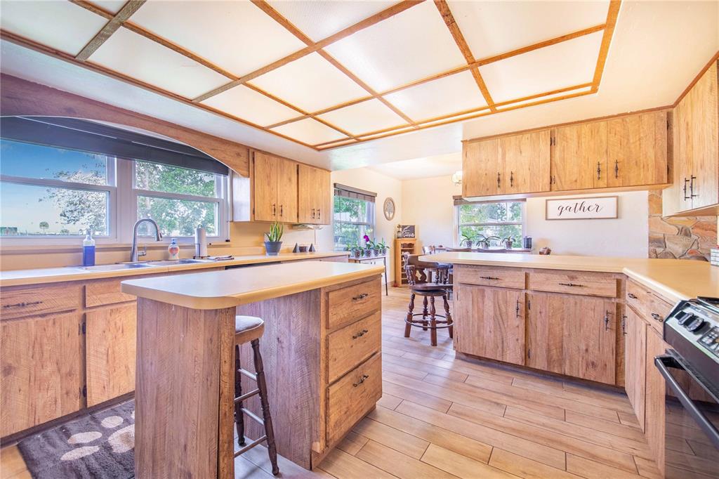 1646 Tyner Road Haines City, FL 33844 - Photo 18 of 64 a kitchen with stainless steel appliances granite countertop a sink a counter space and a large window