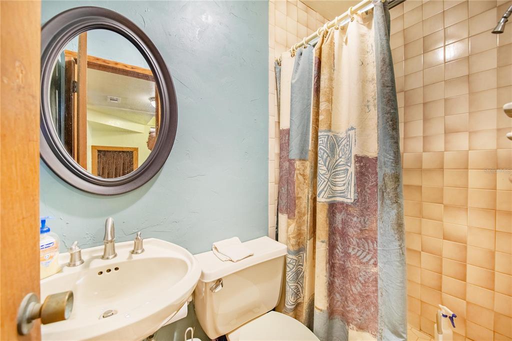 1646 Tyner Road Haines City, FL 33844 - Photo 20 of 64 a bathroom with a sink a mirror a toilet and a shower