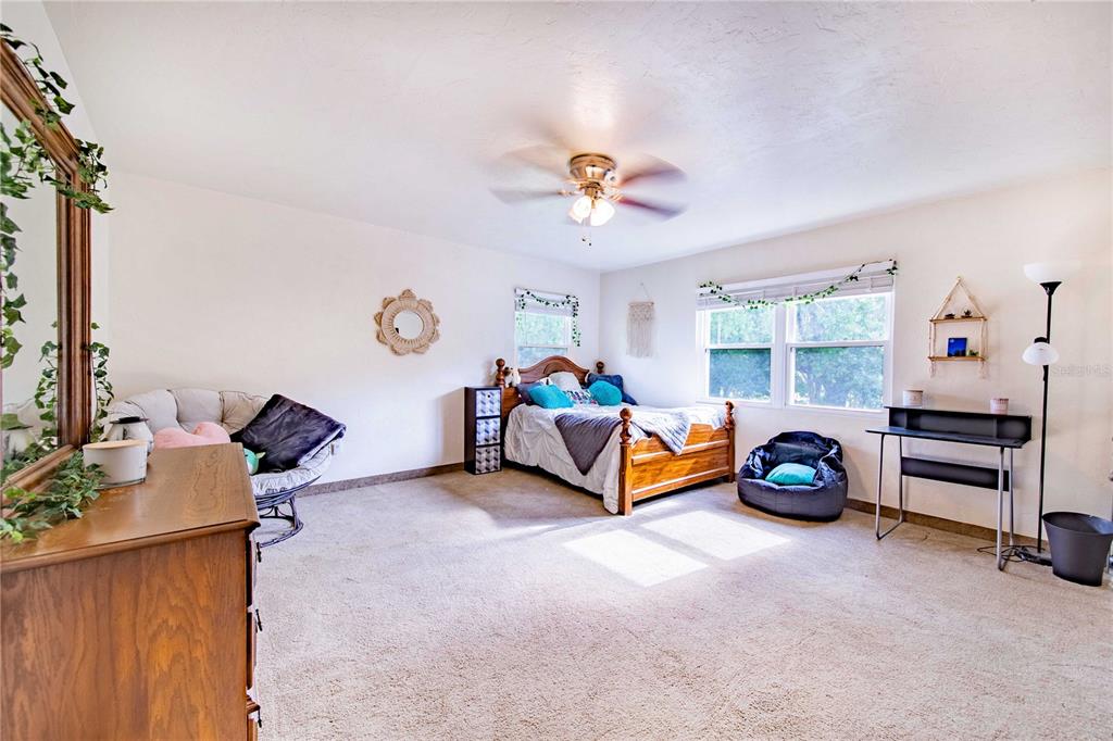 1646 Tyner Road Haines City, FL 33844 - Photo 25 of 64 a bedroom with furniture and a chandelier