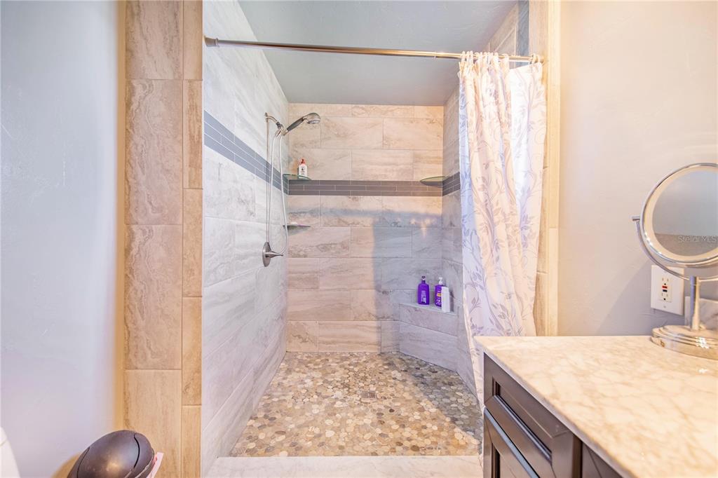 1646 Tyner Road Haines City, FL 33844 - Photo 30 of 64 a bathroom with a granite countertop sink and a mirror