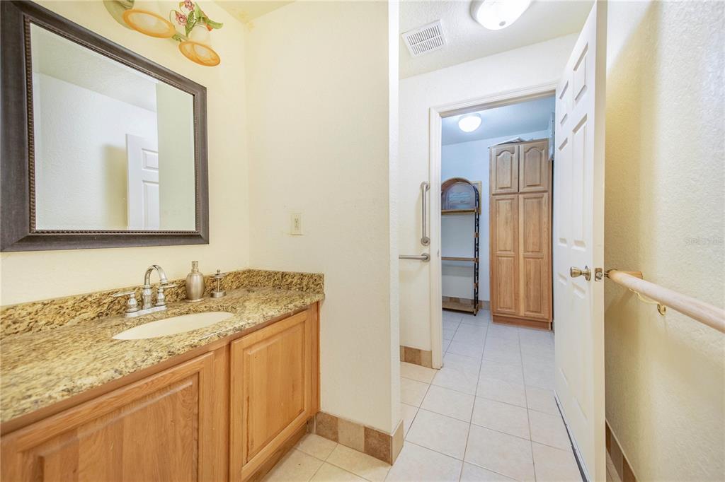 1646 Tyner Road Haines City, FL 33844 - Photo 42 of 64 a en suite bathroom with a granite countertop sink and a mirror