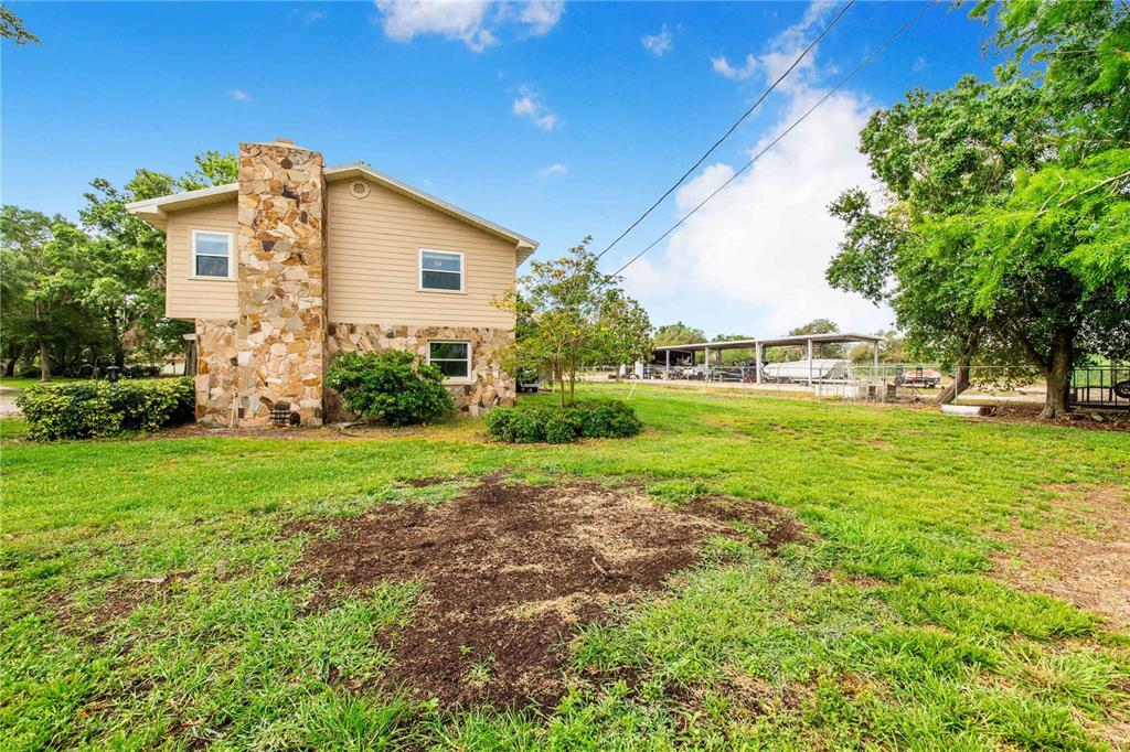 1646 Tyner Road Haines City, FL 33844 - Photo 52 of 64 a view of a house with backyard and garden