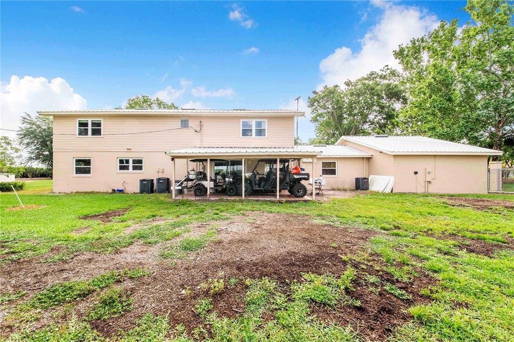 1646 Tyner Road Haines City, FL 33844 - Photo 53 of 64 a view of a house with backyard and a garden