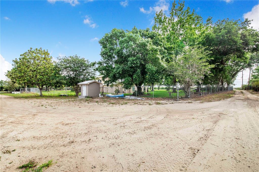 1646 Tyner Road Haines City, FL 33844 - Photo 56 of 64 a backyard of a house with a trees and plants