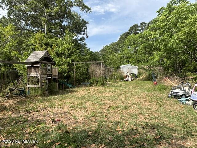 85336 Crews Road North Fernandina Beach, FL 32034 - Photo 8 of 8 a backyard of a house with lots of green space