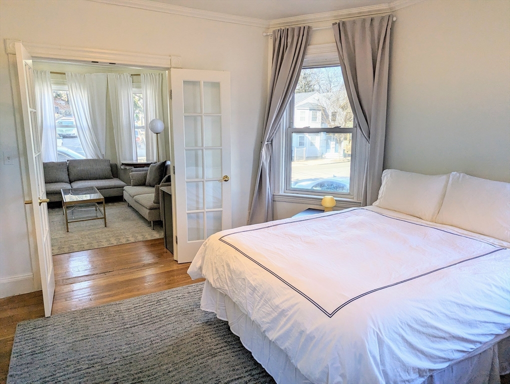 60 Day Street, Unit 1 Boston, MA 02130 - Photo 5 of 10 a bedroom with a bed and a large window
