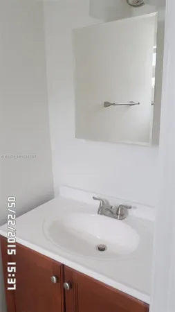 a white toilet sitting next to a white sink