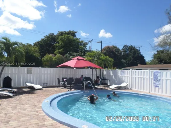 a view of a backyard with swimming pool