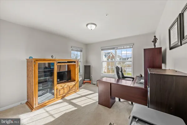 a living room with furniture a flat screen tv and large window