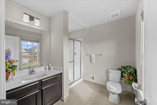 a bathroom with a sink toilet and a mirror