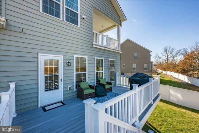 a view of a house with a small deck and wooden floor