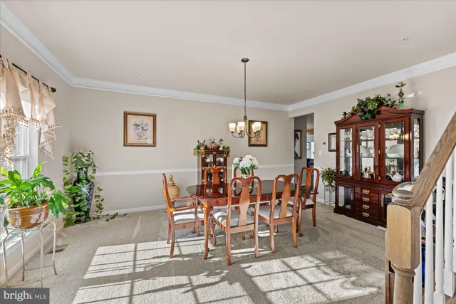 a view of a dining room with furniture and chandelier
