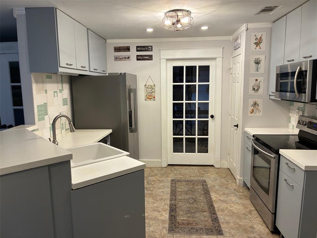 11607 Harbor Road Frisco, TX 75035 - Photo 3 of 10 a kitchen with stainless steel appliances granite countertop a sink stove and refrigerator