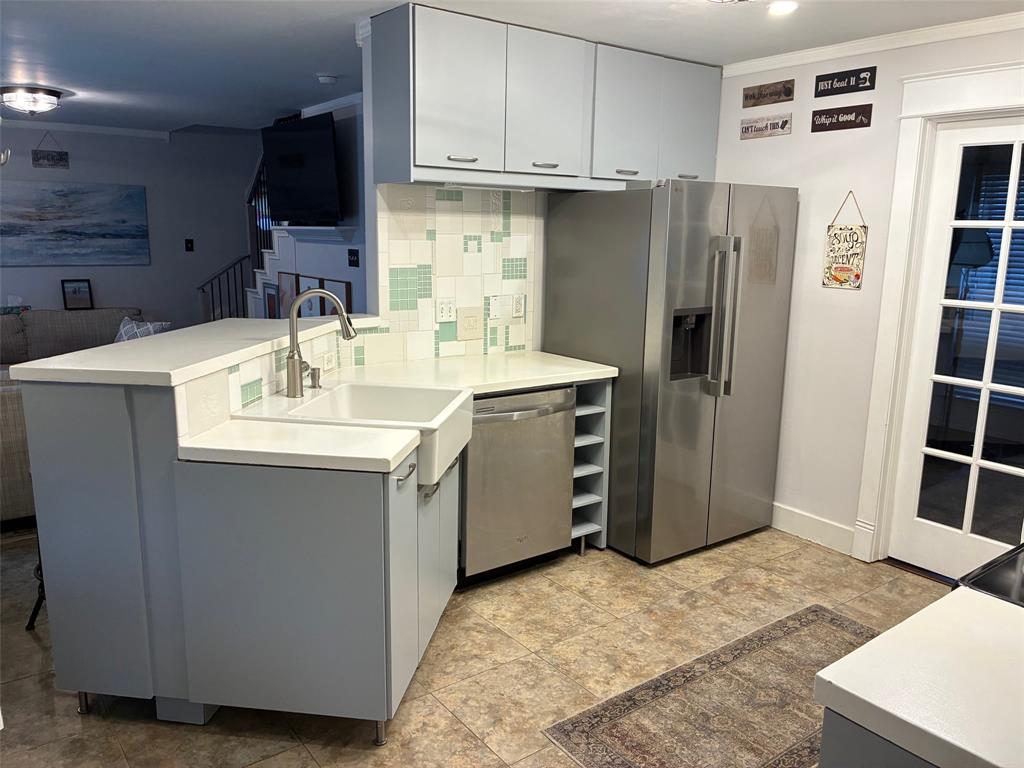 11607 Harbor Road Frisco, TX 75035 - Photo 4 of 10 a kitchen with stainless steel appliances a sink a stove a refrigerator and cabinets