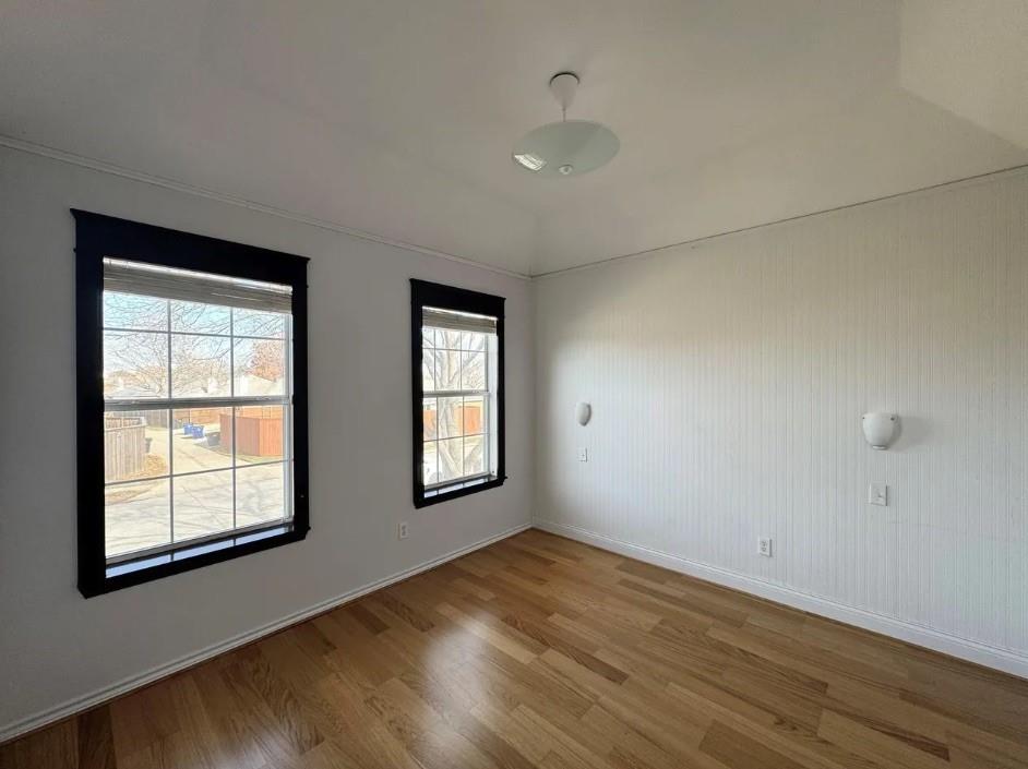 11607 Harbor Road Frisco, TX 75035 - Photo 6 of 10 a view of an empty room with wooden floor and a window