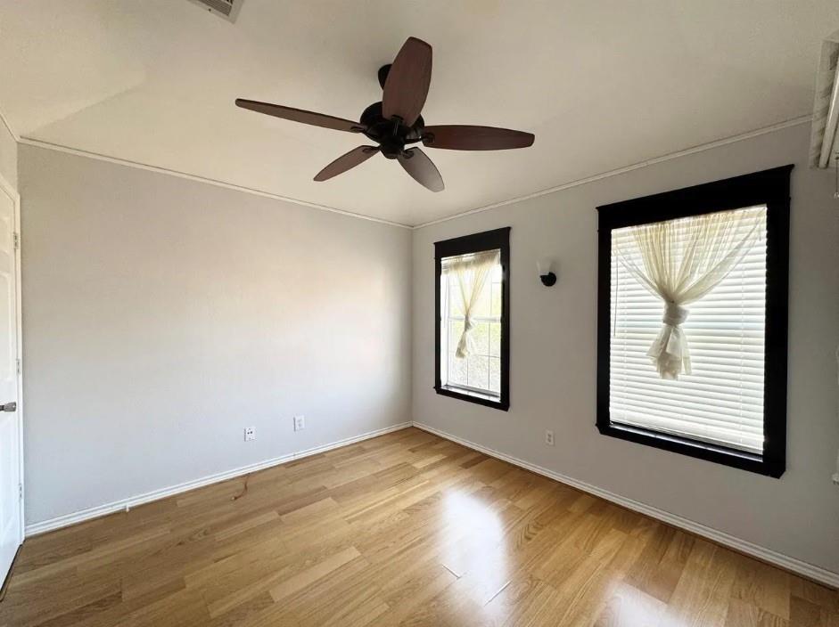 11607 Harbor Road Frisco, TX 75035 - Photo 7 of 10 a view of an empty room with wooden floor and a window