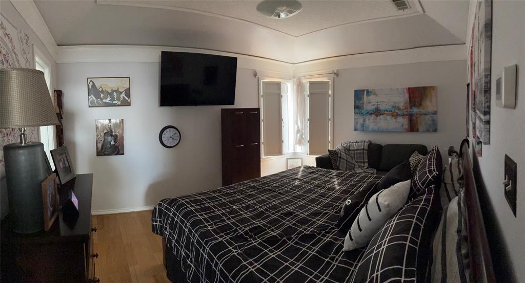 11607 Harbor Road Frisco, TX 75035 - Photo 8 of 10 a bedroom with a bed and a flat screen tv