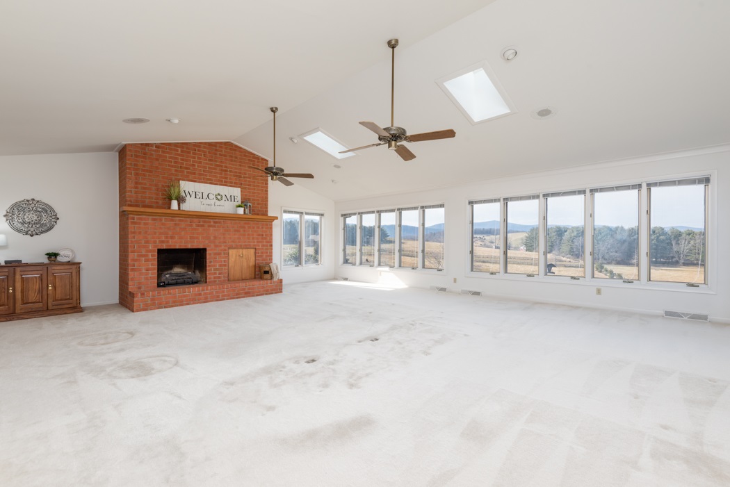 73 B Swoope Road Swoope, VA 24479 - Photo 11 of 75 a view of an empty room with a fireplace and a window