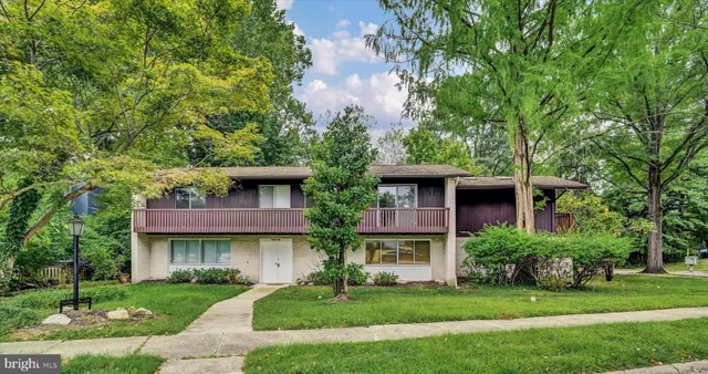 front view of a brick house with a yard