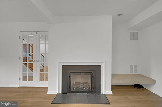 a living room with a fireplace and a book shelf