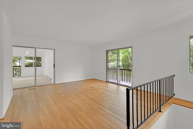 a view of a room with wooden floor and a window