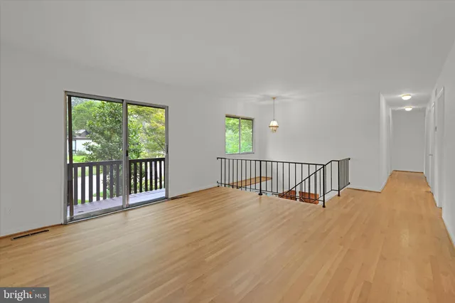 a view of a room with wooden floor