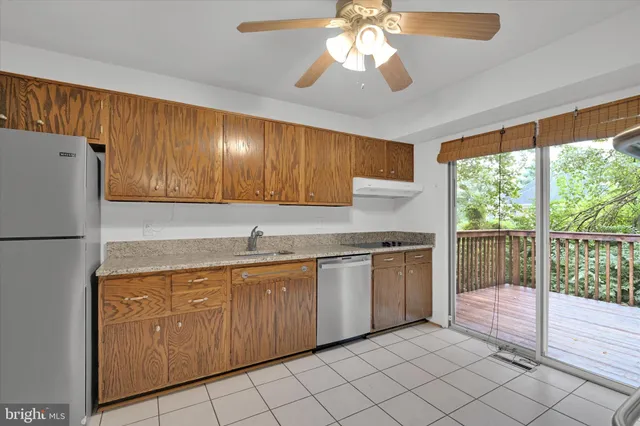 a kitchen with granite countertop stainless steel appliances a stove sink and microwave