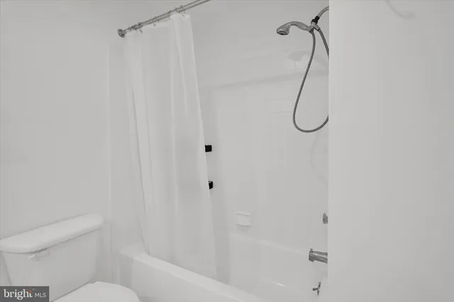 a bathroom with a bath tub with a shower