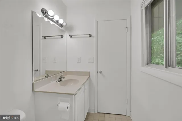 a bathroom with a sink and mirror