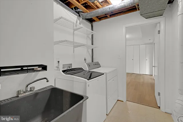 a kitchen with a sink a refrigerator and chandelier