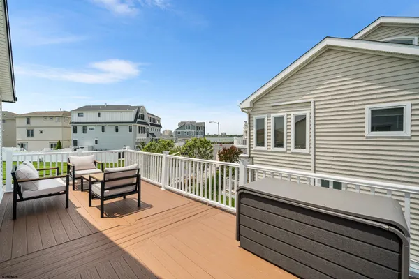a view of a roof deck with furniture