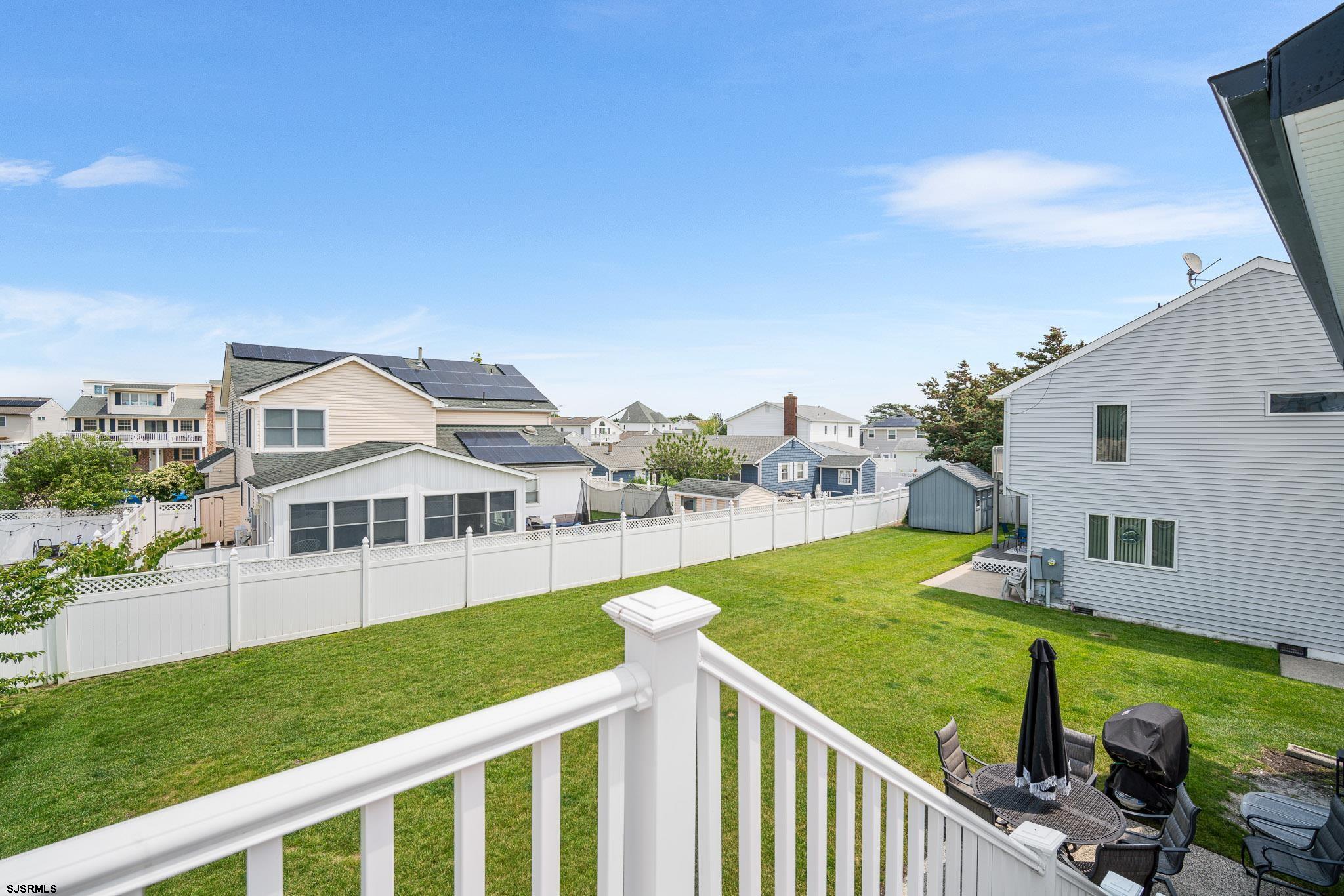 5217 Seaspray Road Brigantine, NJ 08203 - Photo 14 of 35 a view of a house with wooden deck and furniture
