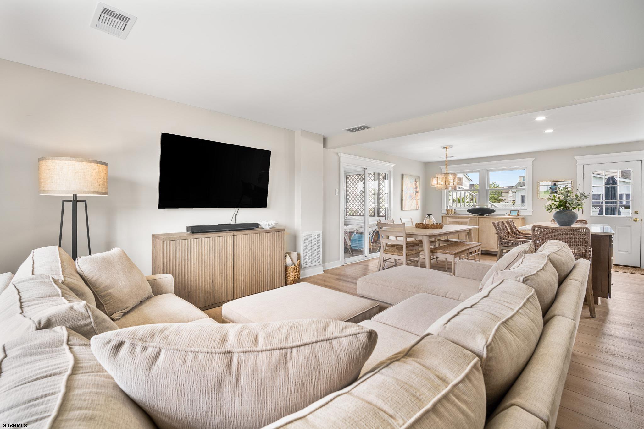 5217 Seaspray Road Brigantine, NJ 08203 - Photo 25 of 35 a living room with furniture and a flat screen tv