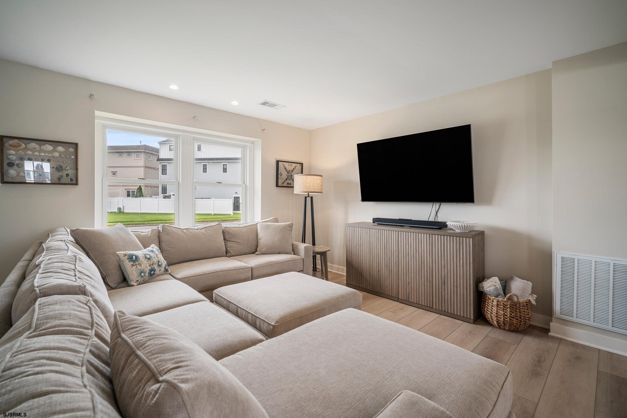 5217 Seaspray Road Brigantine, NJ 08203 - Photo 30 of 35 a living room with furniture and a flat screen tv