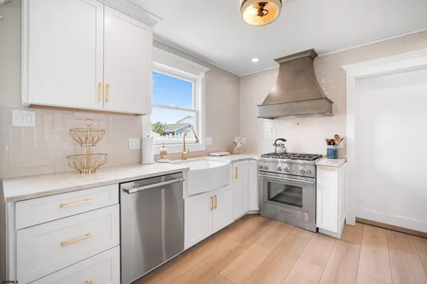a kitchen with stainless steel appliances a sink and a stove
