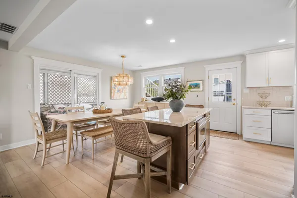 a dining room with furniture and wooden floor