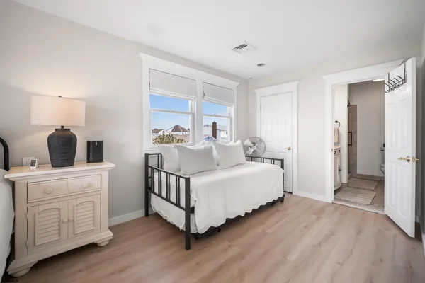 a room with a bed and a dresser