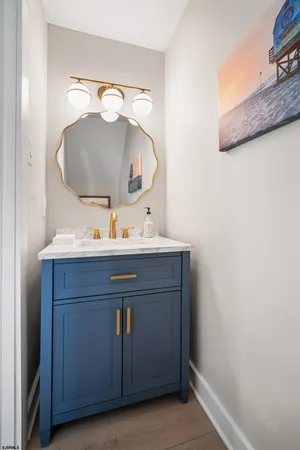 a bathroom with a sink vanity and mirror