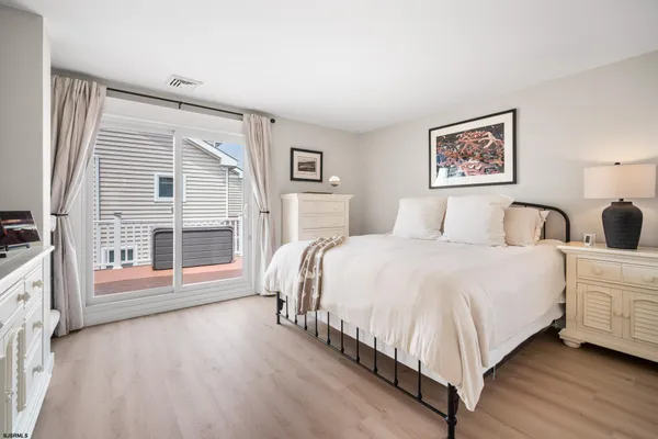 a spacious bedroom with a bed and a large window