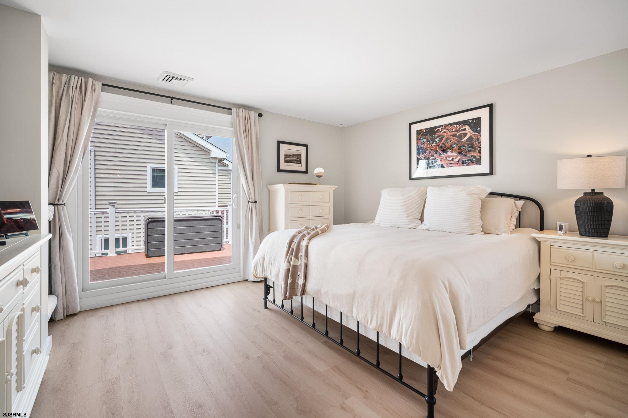 5217 Seaspray Road Brigantine, NJ 08203 - Photo 9 of 35 a spacious bedroom with a bed and a large window