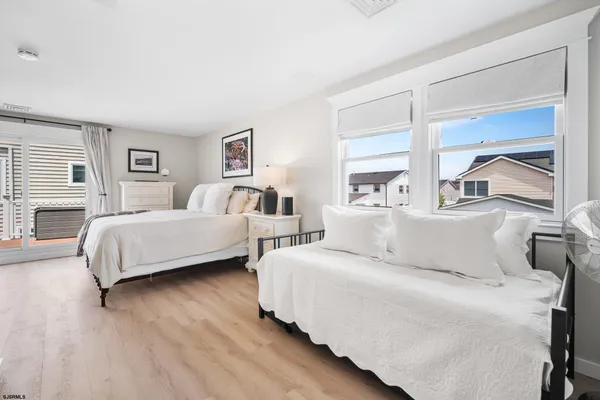 a bedroom with two beds and a large window