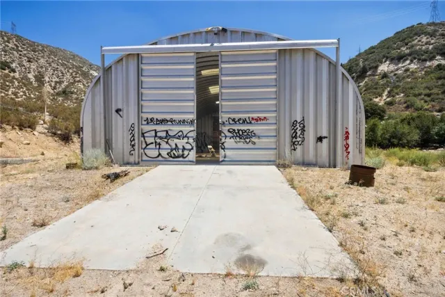 a view of a dry yard with mountains in the background